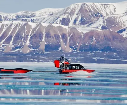 Airboat with snowy mountains in background